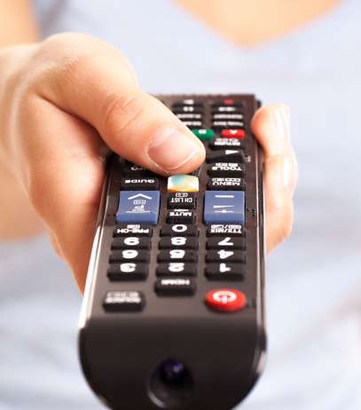 Woman's hand press on TV console button